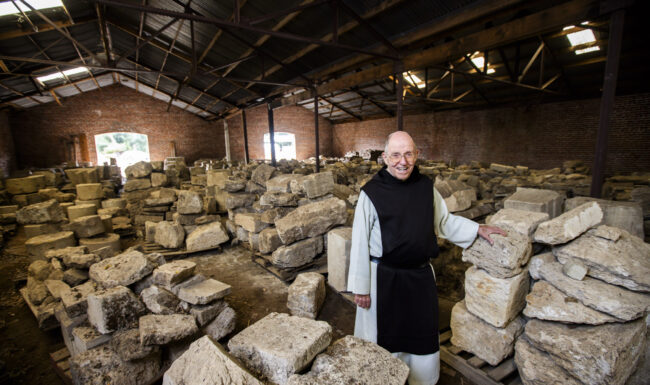 Fr. Thomas in a room with many large rocks