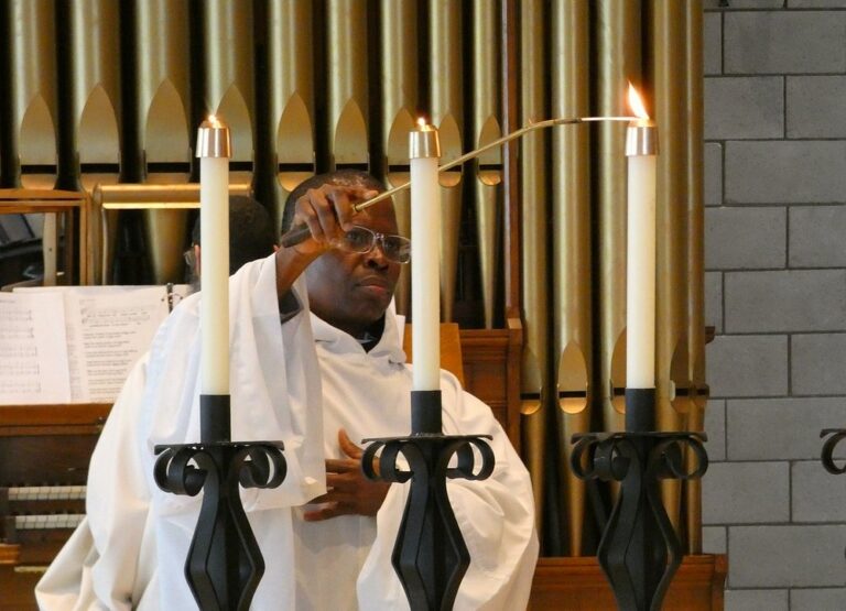 A Trappist monk lights candles for Holy Mass