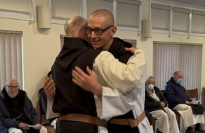 Dom Paul Mark hugs Brother Isaac in congratulation at his first vows